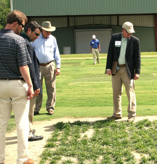 UGA turfgrass breeder Brian Schwartz (right) examines research plots during the turfgrass conference held in 2013.
