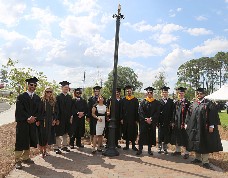Spring graduates gather around the centennial whistle following a special ceremony honoring the UGA-Tifton graduates on Saturday, May 4, on the UGA Tifton campus.