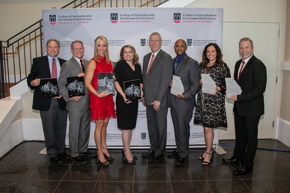 UGA CAES Dean Sam Pardue, center, congratulates CAES alumni Ken Foster, Charlie Broussard, Jaime Hinsdale Foster, Andrea B. Simao, Franklin West, Sarah Dunn and Tamlin Hall during the 65th CAES Alumni Association Awards Banquet on Oct. 4 in Athens, Georgia.