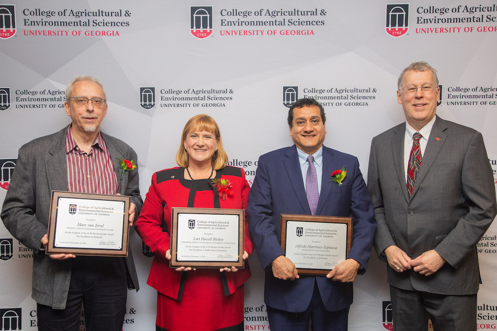 D.W. Brooks Award of Excellence winners Marc van Iersel, Vincent J. Dooley Professor of Horticulture; Lori Purcell Bledsoe, Georgia 4-H program development coordinator for Northeast Georgia; and Alfredo Martinez-Espinoza, professor of plant pathology, are congratulated by CAES Dean and Director Sam Pardue.