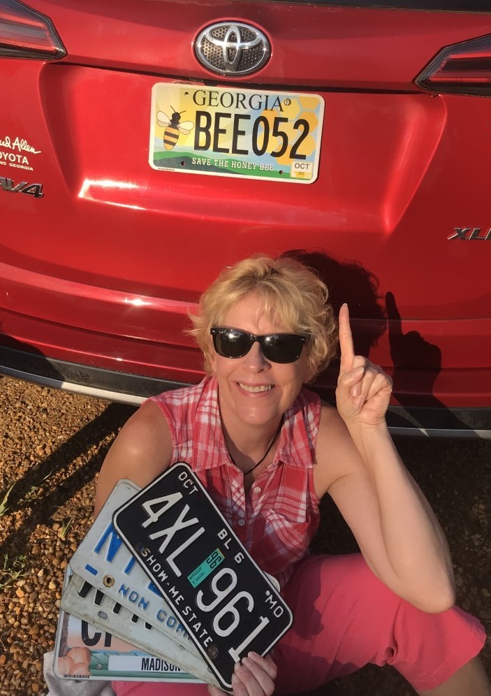 Jennifer Berry, an apiculture research professional and lab manager for the University of Georgia Honeybee Program, proudly displays her "Save the Honeybee" Georgia license plate. Thanks to the work of the Georgia Beekeepers Association Georgians can now buy the tag at the GBA website (gabeekeeping.com).