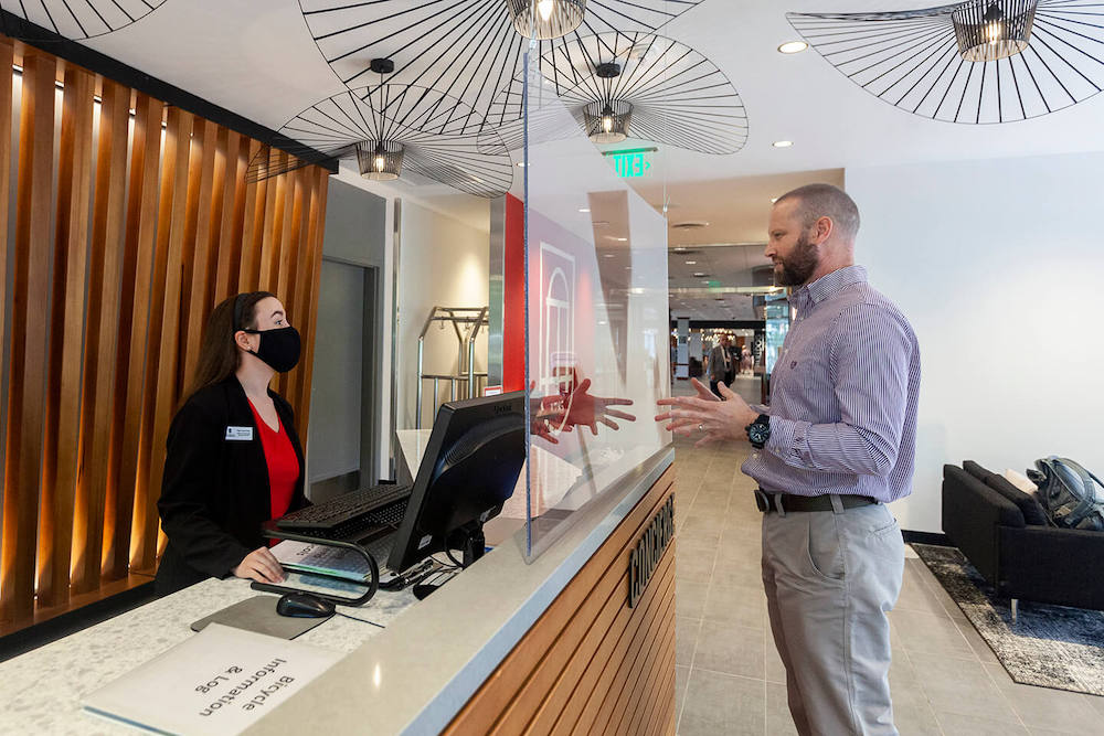 Tyler Grace Hunt (left), a fourth year Hospitality and Food Industry Management major, helps a guest while working at concierge desk of the Georgia Center. (Photo: Shannah Montgomery/PSO)