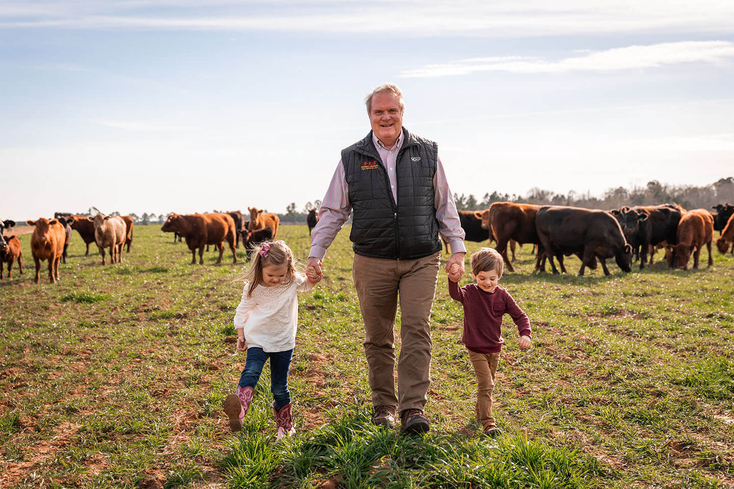 Keith Kelly walks with his grandchildren on the Rock House Creamery family farm. (Submitted photo: Rock House Creamery)