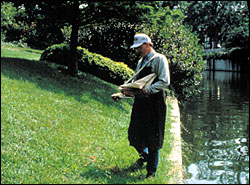 Person standing next to a pond