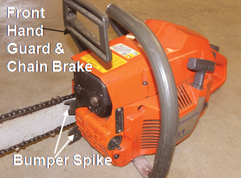 Chainsaw with safety features labeled: front hand guard & chain brake, and bumper spike