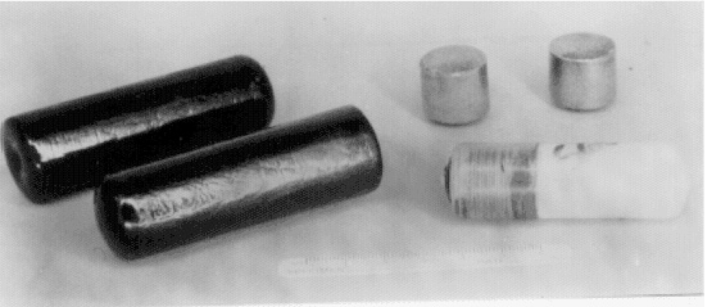 Figure 8. Soluble glass boluses (left), iron-based heavy pellets (back right) and an osmotic pump (front right).