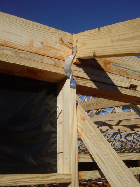Trusses tied to the top of a wall using “hurricane straps