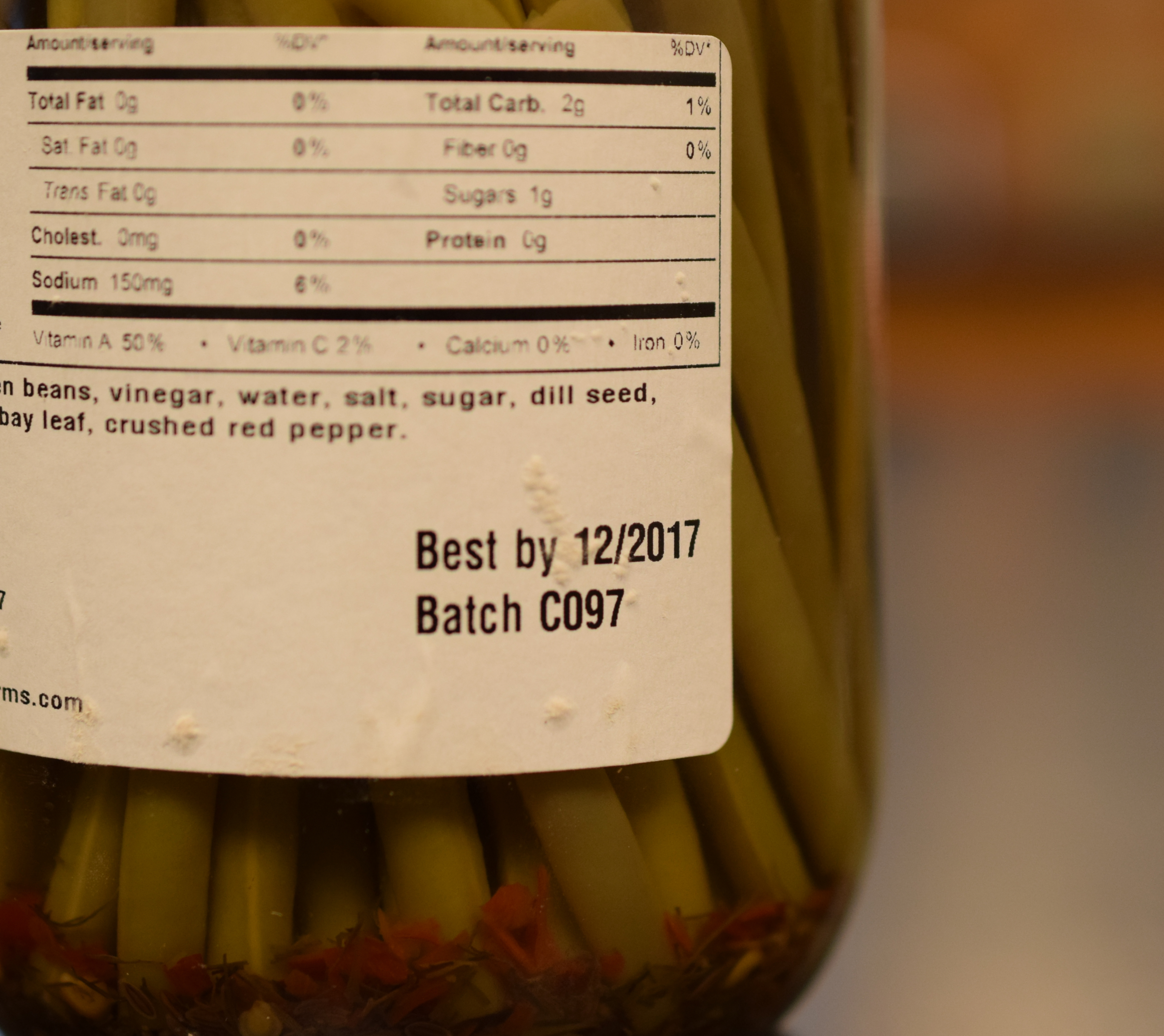 Label on a jar of pickled green beans that says "Best by 12/2017" and "Batch C097"