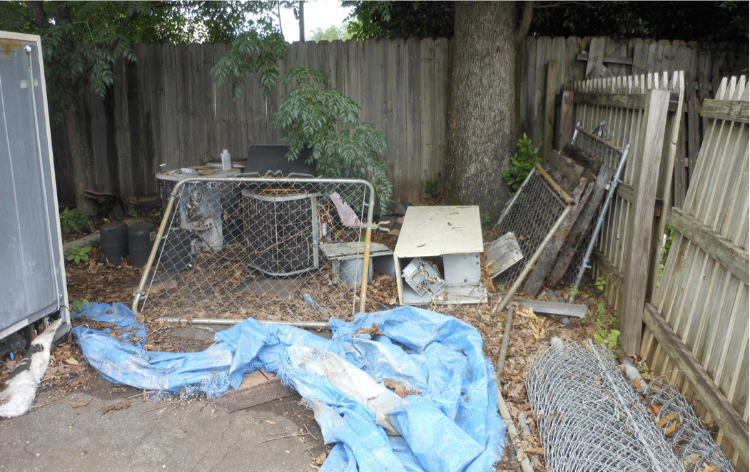 Old tarps and hollow pipes in a yard