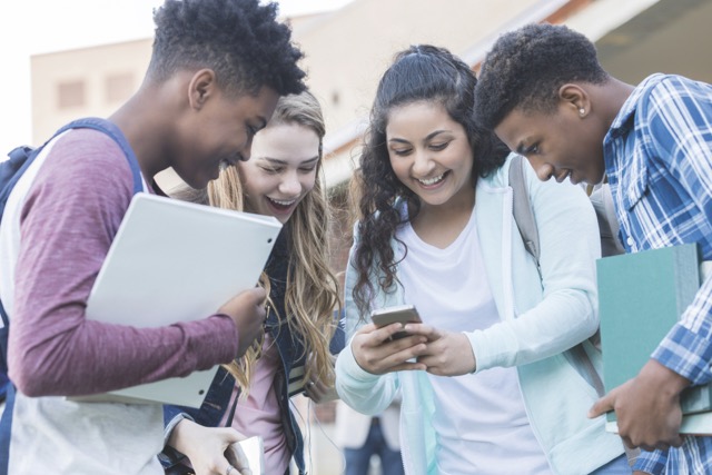 Kids around a phone