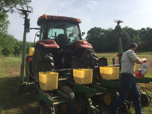 Person adding seed to a no-till planter