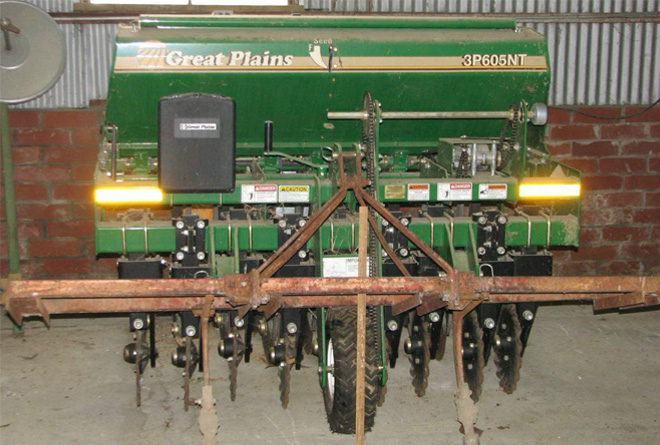 Front of a no-till drill showing the coulters.