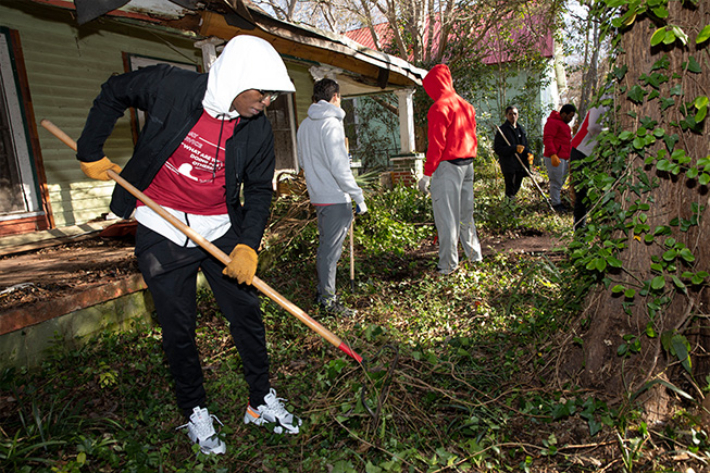 People cleaning yard