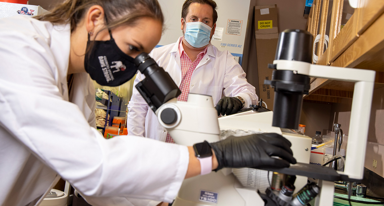 Girl looking through microscope