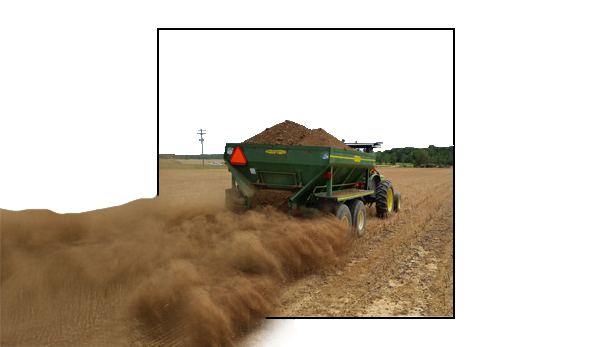 Applying chicken litter to field using mechanical spreader