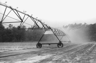 photo of center pivot irrigation system with medium pressure impact sprinklers.