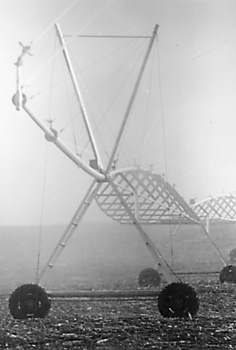 Photo of center pivot irrigation system with high pressure impact sprinklers and end gun.