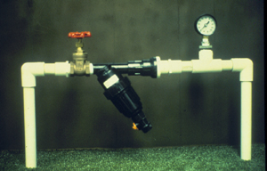 Control station for small drup irrigation valve with a drip emitter, control valve, and pressure gauge