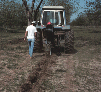 Installing lateral line using subsoil plow.