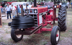 Tractor holding a coil of lateral irrigation line