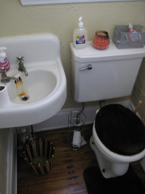 Bathroom sink with rust colored stains under the faucet