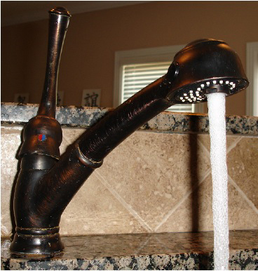 Photo of a kitchen faucet with running water