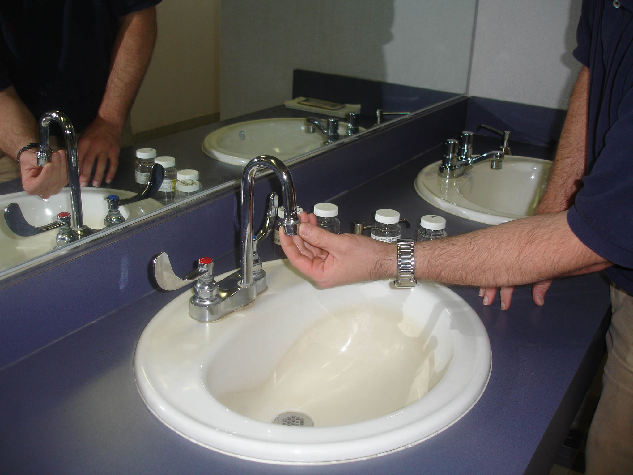 Photo showing the removal of aerator from sink faucet