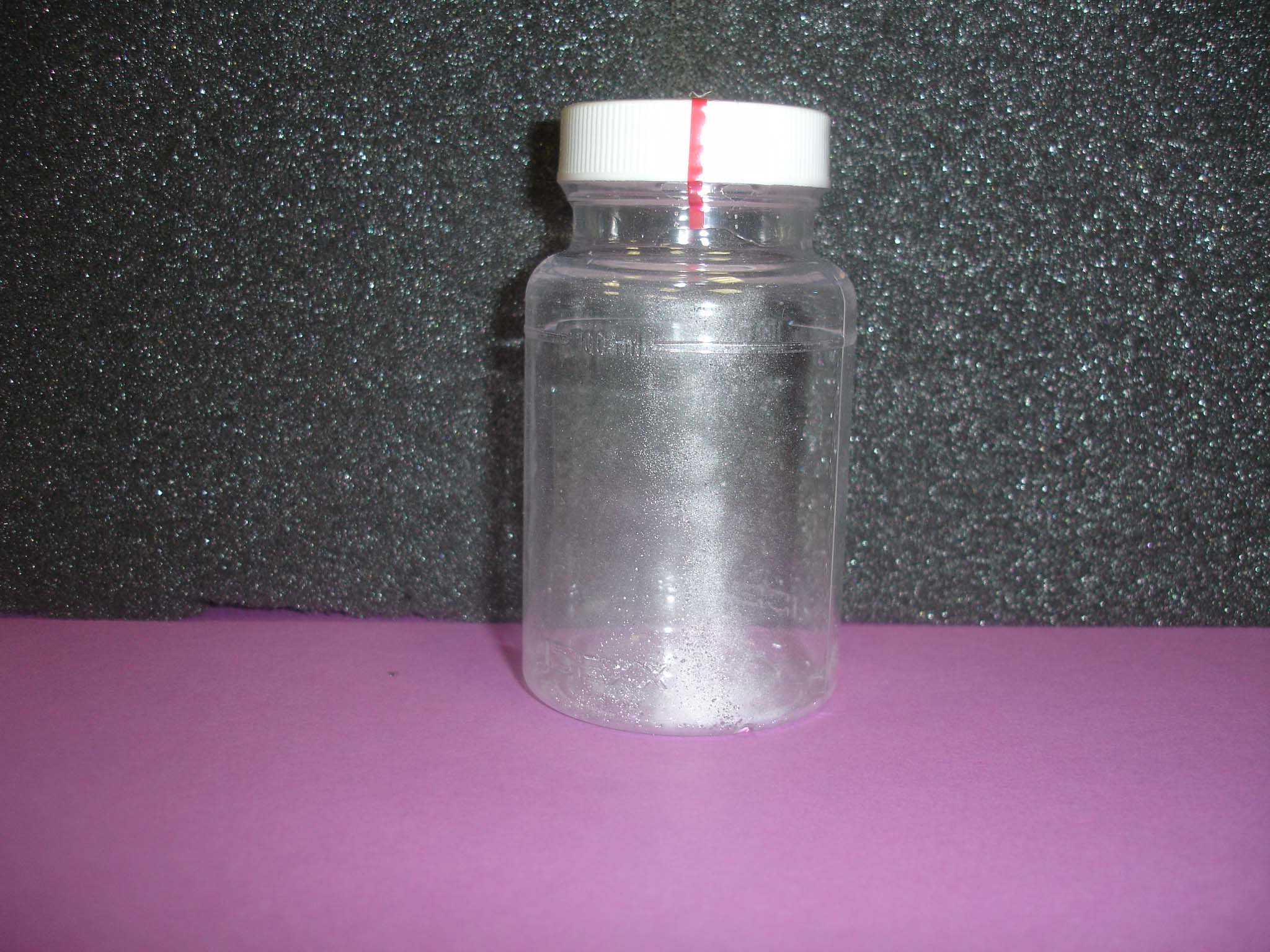 Photo of sterile, empty water sample bottle with tamper-proof seal