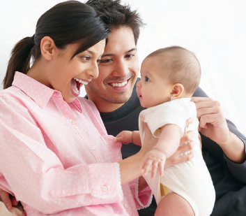 Parents making happy faces at baby they're holding.