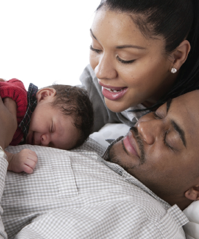 baby with parents (stock photo)