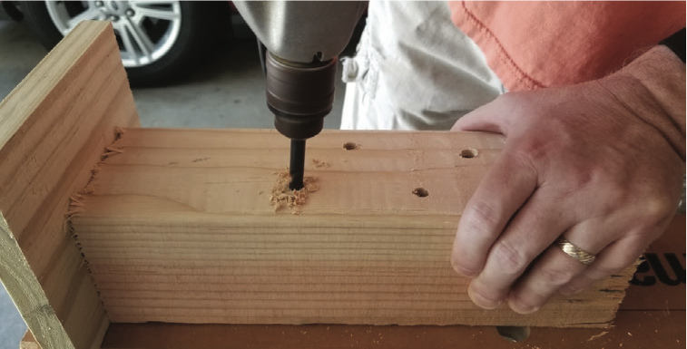 A person drilling into wood