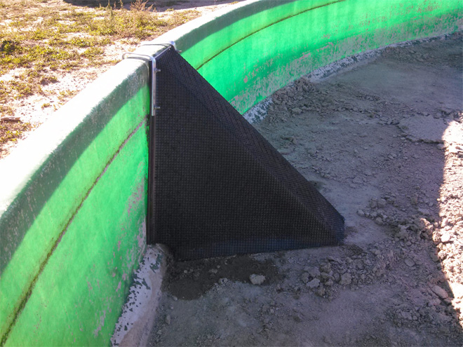 A wildlife escape ramp in a water tank. It is a triangular ramp attached to the wall of the tank.