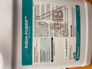 A close-up of an Aqua Power brand liquid fertilizer's label.