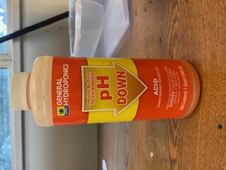 an orange bottle with yellow labeling reads ph down