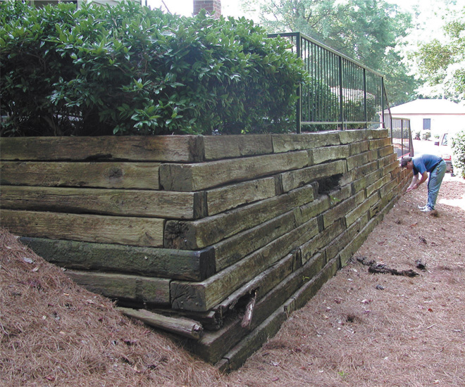 Retaining wall constructed from railroad crosses.