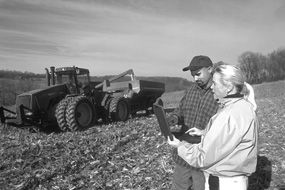 Farmer looking at test results in a field