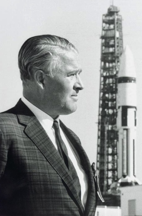 Dr. Wernher von Braun stands in front of a Saturn IB launch vehicle at Kennedy Space Flight Center. He led a team of German rocket scientists, called the Rocket Team, to the U.S., first to Fort Bliss/White Sands, later to the Army Ballistic Missile Agency at Redstone Arsenal in Huntsville, Alabama.