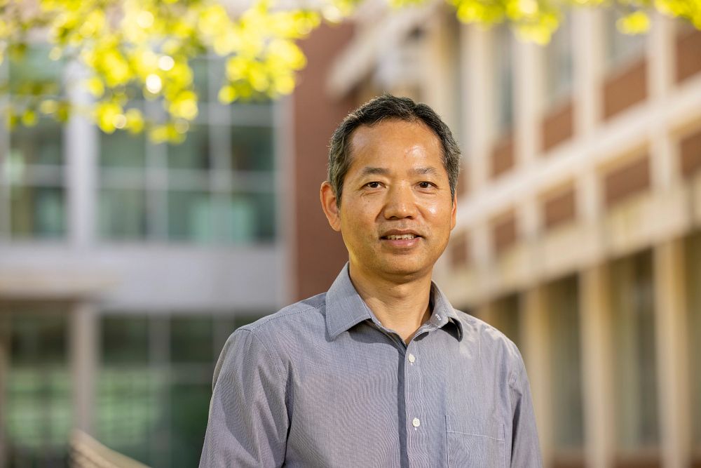 Environmental portrait of Fanbin Kong outside the food science building.