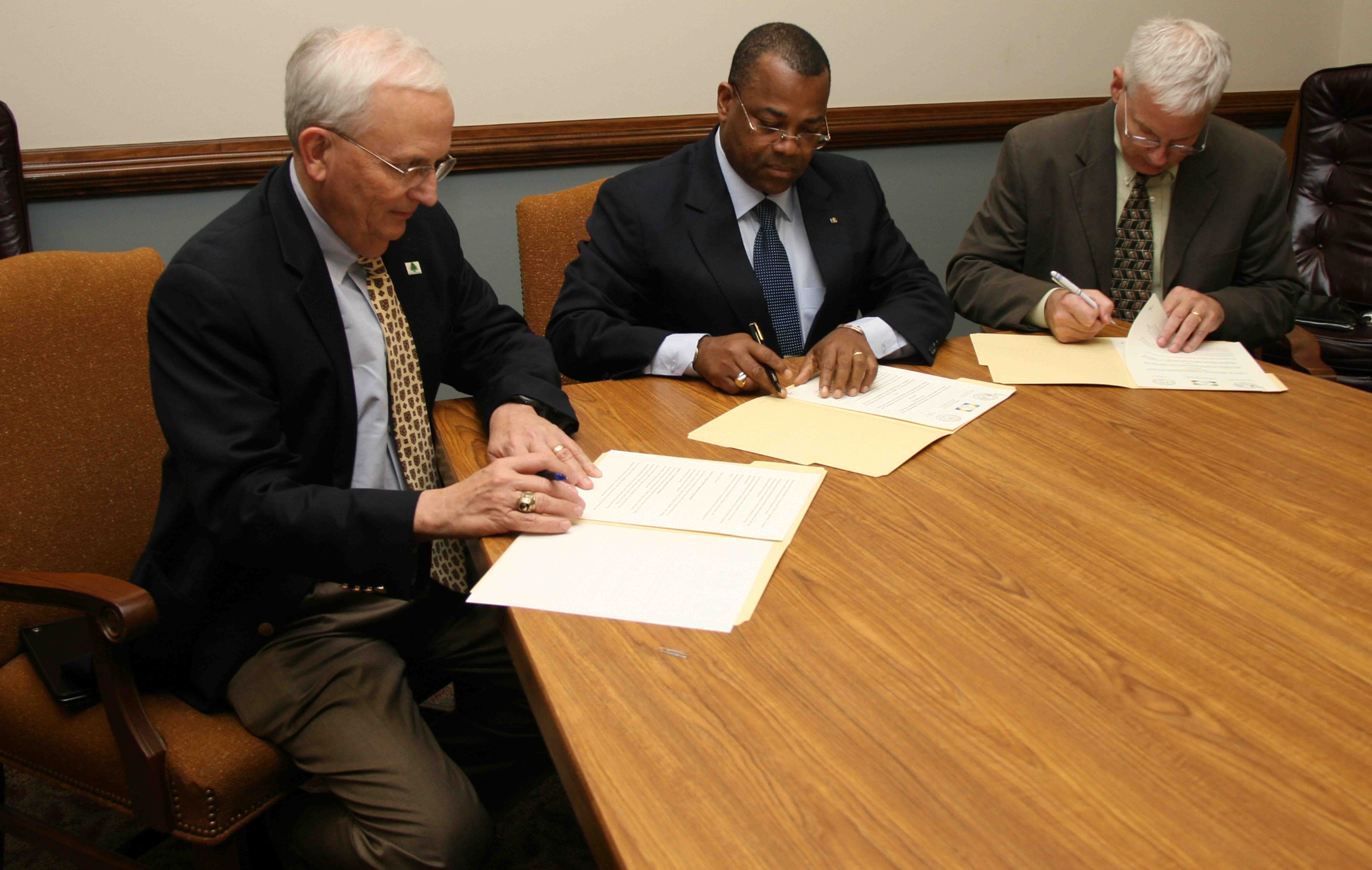 Georgia Commissioner of Agriculture Gary Black, Gabon's Minister of Agriculture, Livestock Fisheries and Rural Development, Julien Nkoghe-Bekale and UGA College of Agriculture and Environmental Sciences Dean J. Scott Angle sign an agreement promising future cooperation on agricultural development projects on Nov. 20.