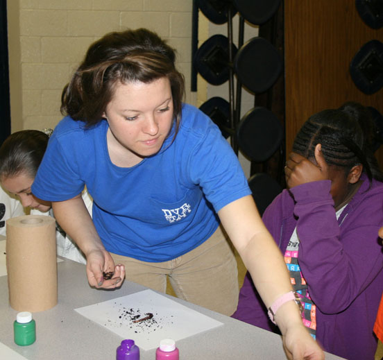 UGA student Kaitlyn Lancaster passes out worms during her exhibit, while Alicia Boone (right) can't watch.