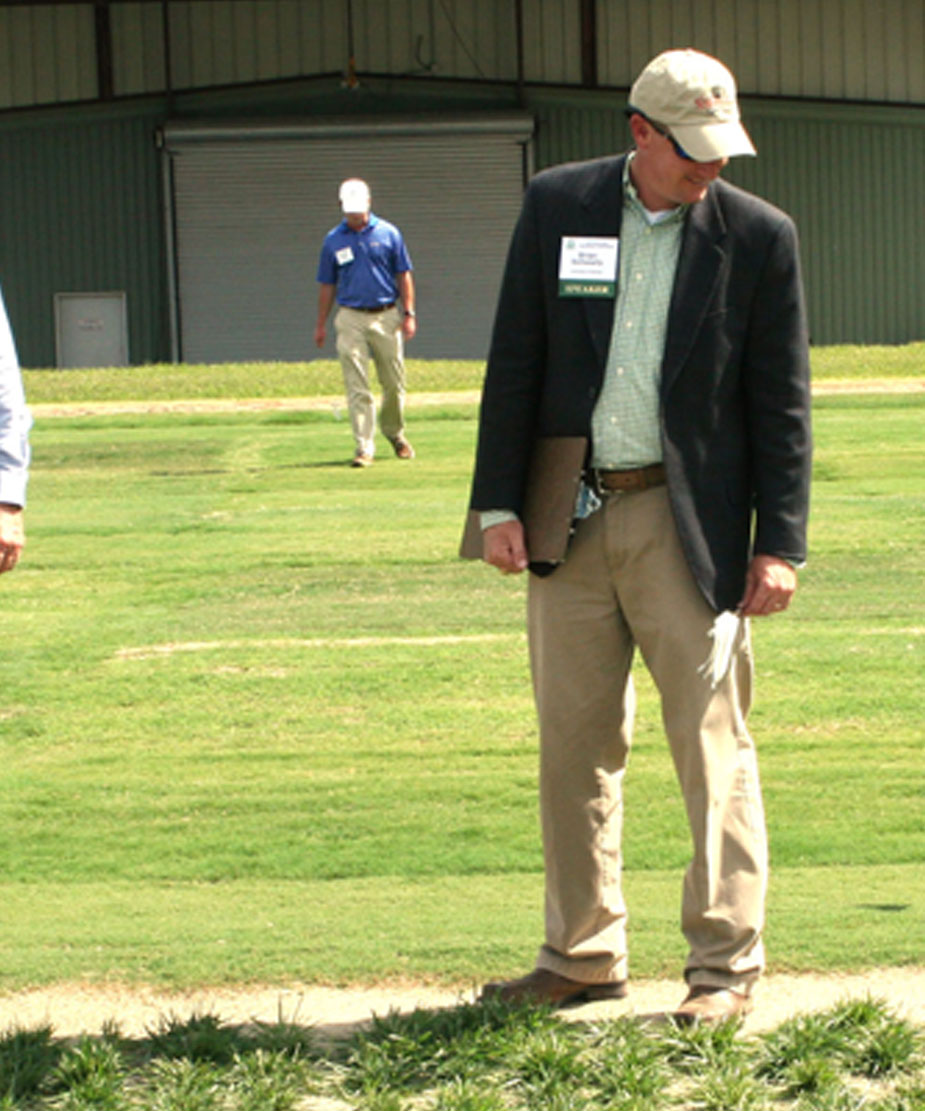 UGA turfgrass breeder Brian Schwartz (right) examines research plots during the turfgrass conference held in 2013.