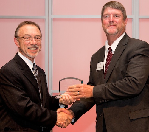 University of Georgia horticulturist Scott NeSmith (right) is shown receiving the 2013 Inventor's Award from UGA Vice President for Research David Lee.