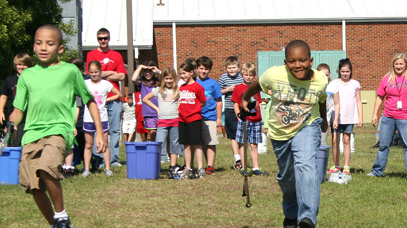 Third graders participate in a recycling relay race.