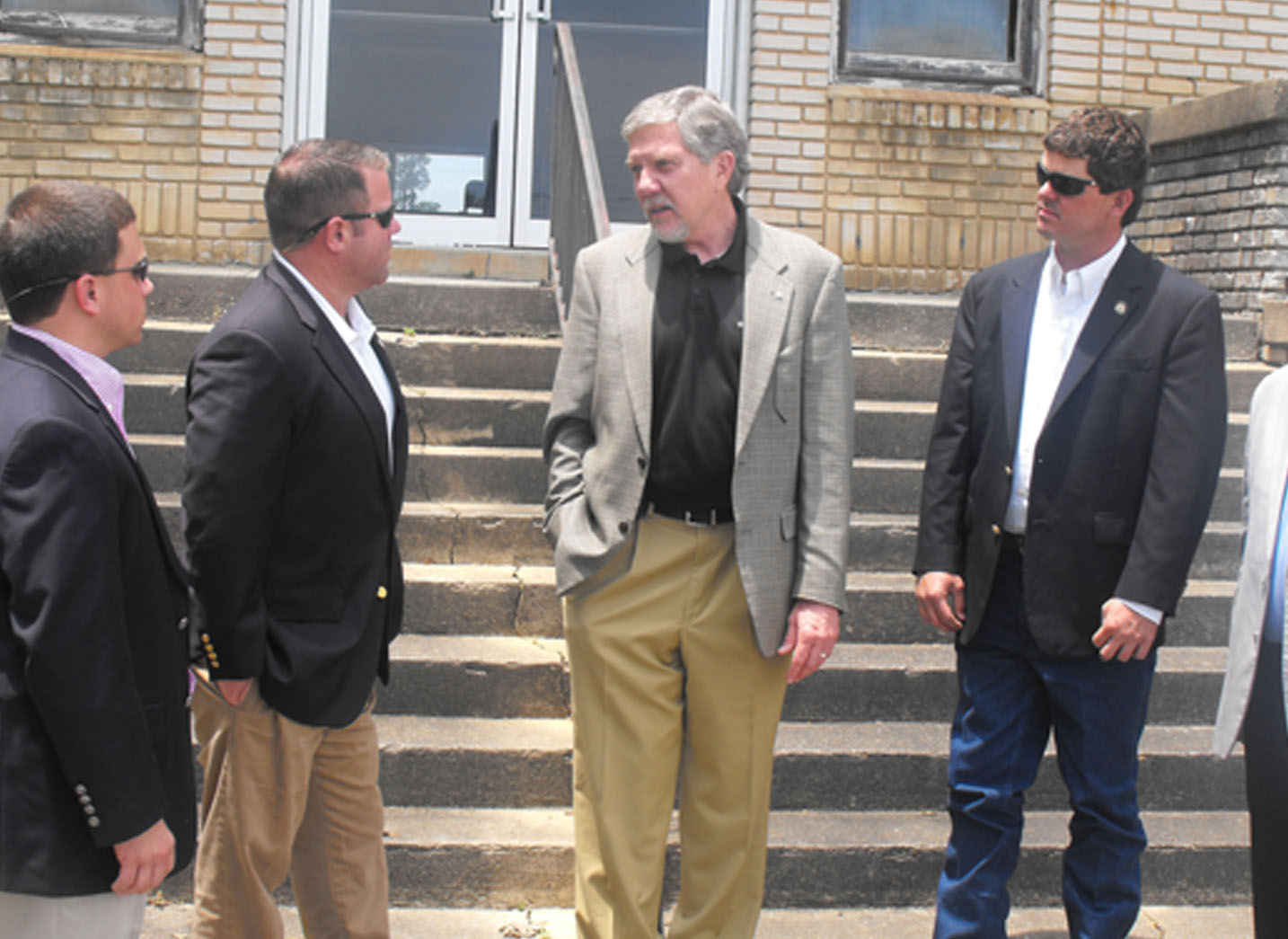 Dr. Joe West speaks with legislators in front of the H.H. Tift Building, which will undergo a complete renovation. Pictured with West are, from left, Sen. Tyler Harper, Rep. Jay Roberts, Dr. West, Rep. Sam Watson and Sen. John Crosby.