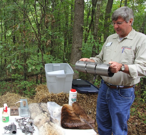 University of Georgia Cooperative Extension wildlife expert Michael Mengak tells visitors to a field day how a squirrel trap should be used.