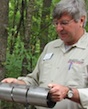 University of Georgia Cooperative Extension wildlife expert Michael Mengak tells visitors to a field day how a squirrel trap should be used.