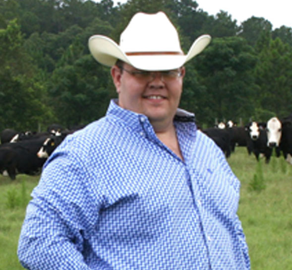 Jacob Segers stands in a cow pasture on the University of Georgia Tifton campus.
