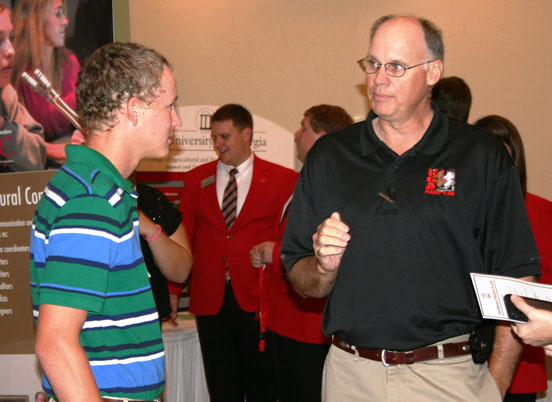 John Beasley, a former professor at the UGA Tifton Campus, talks to a student during a showCAES@UGAsoutheast event. This year's southeast event will be held Oct. 4 in Statesboro.