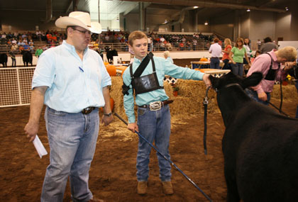University of Georgia beef cattle specialist Jacob Segers talks with Dalton Whitley, an eighth grader from Piedmont Academy in Monticello, Ga., during a junior beef showmanship competition at the Georgia National Fair in Perry on Friday, Oct. 4.