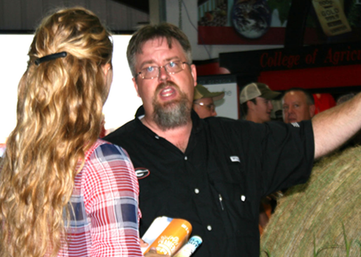 Dennis Hancock, a forage Extension specialist with the University of Georgia College of Agricultural and Environmental Sciences in Athens, speaks to an Expo attendee on the first day of the Sunbelt Ag Expo in Moultrie on Tuesday, Oct. 15.